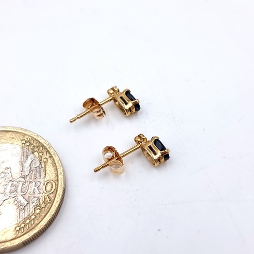 4 - A pair of nine carat gold sapphire stone stud earrings. Boxed.