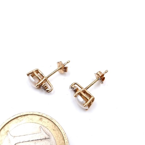 6 - A pair of nine carat gold pearl set stud earrings with lustre earrings  set with diamond accents. We... 