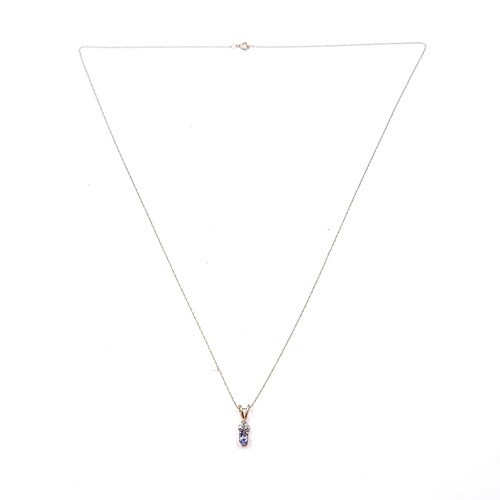 42 - Star Lot : A nice example of a nine carat gold pendant set with blue tanzanite and diamond set stone... 