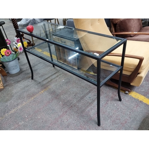 402 - Two-tier black metal console table with tempered glass shelves. A fabulous piece from a Uk design co... 