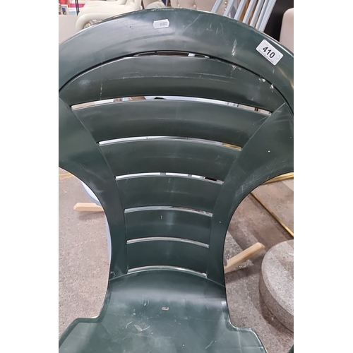 410 - This is a set of two green plastic outdoor chairs that comes with a matching square side table. They... 