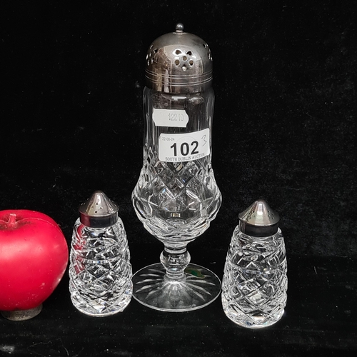 102 - A trio of Waterford Crystal items including pepper pots and a sugar shaker. All with silver plate to... 