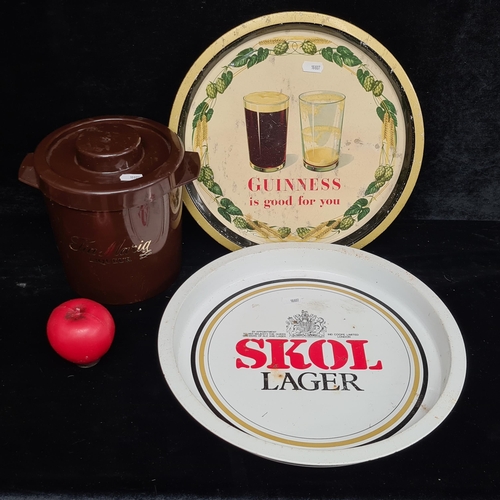 104 - Three vintage pub / bar items including a super 1950's Guinness branded tin drinks tray, a Skol beer... 