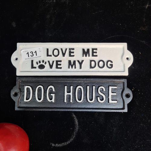 131 - Two heavy cast metal dog themed wall plaques.