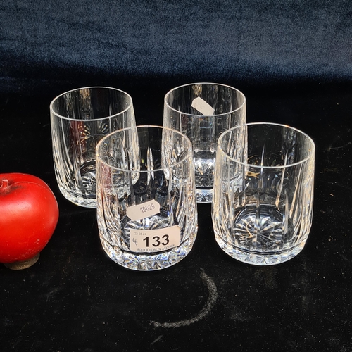 133 - A striking set of four large Waterford Crystal whiskey tumbler glasses in the Blackrock  pattern, al... 