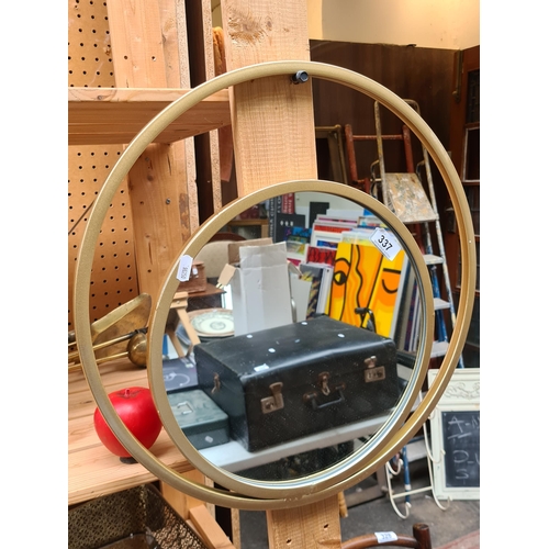 337 - A gorgeous abstract double infinity circular wall mirror with gold toned metal frame. Brand new from... 