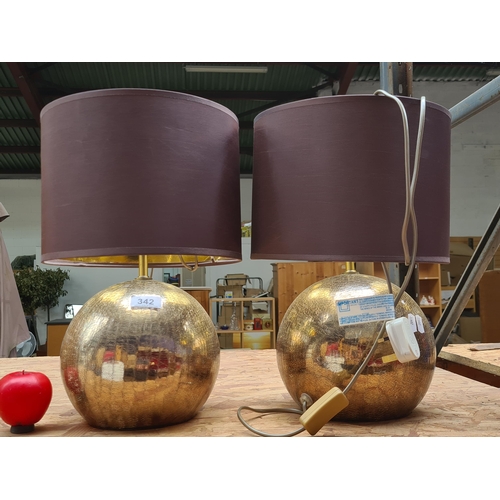 342 - Two gold toned circular table lamps with chocolate brown shades and in line on and off switches .