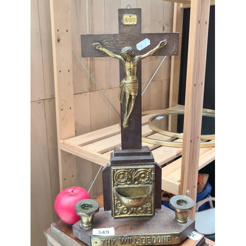 349 - A vintage wooden crucifix adorned with brass accents sits in the centre flanked by two candlesticks.... 