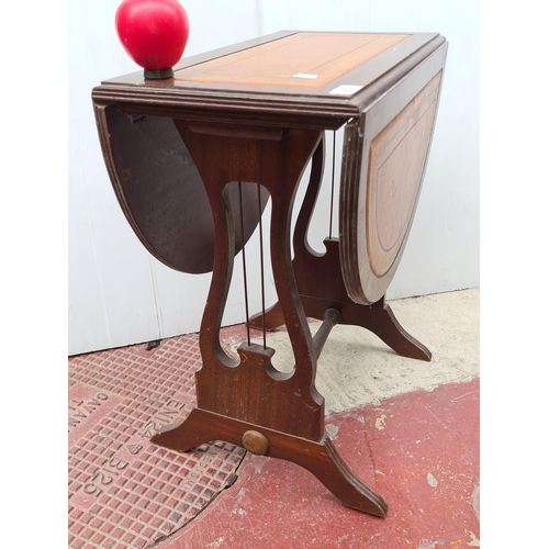 353 - A vintage drop leaf table featuring lyre sides, three leather panels to top with embossing and gilt ... 