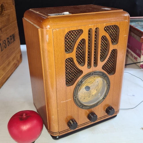 362 - A repo of the 1934 Bush R701 wireless wooden surround table top radio.