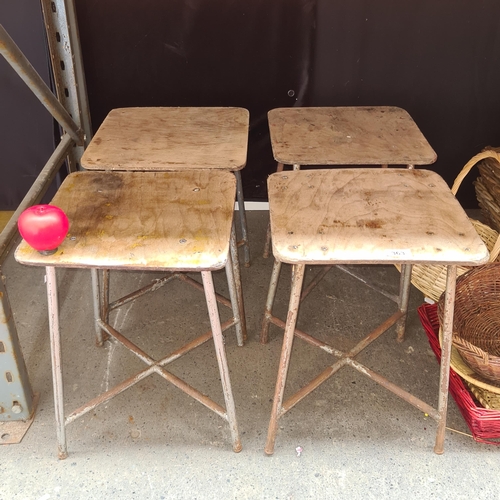 363 - Four vintage fab low lab stools with wooden tops and metal framed legs.