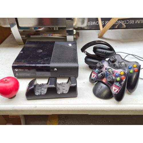 370 - An Xbox 360 E Console with additional accessories such as two controllers and headset. Cables for co... 