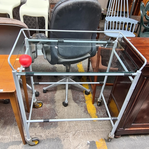 382 - A vintage two tier large trolley with metal frame, one glass shelf and castor wheels.