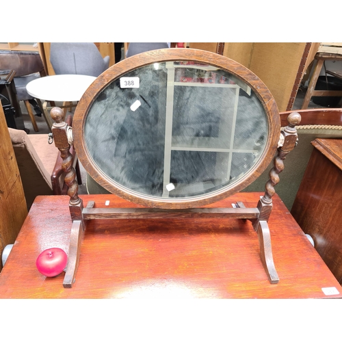 388 - A lovely antique, 19th century stained oak, oval dressing table bevelled mirror flanked by barley tw... 