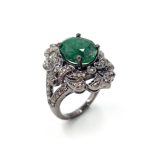 18 - Star Lot : A most attractive emerald stone ring set with a diamond foliette mount. Set in sterling s... 