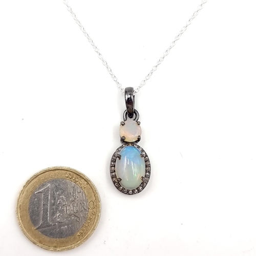 19 - Star Lot : A fine example of a double opal pendant with diamond mount with sterling silver chain. Le... 