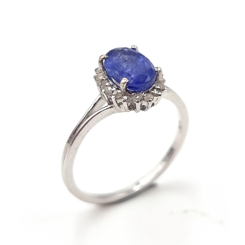 20 - Star Lot : A very nice example of a sapphire gemstone ring set with diamond surround set in sterling... 