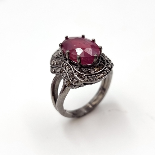 22 - Star Lot : A fabulous example of a large ruby stone ring with claw mount with a diamond surround. Ri... 