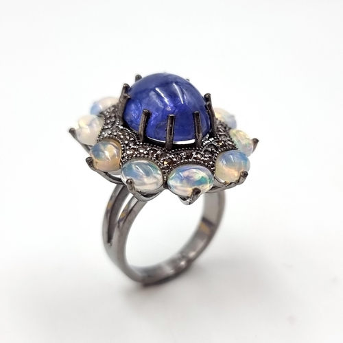 24 - Star lot : An amazing blue petal cabochon sapphire gemstone ring set with raised mount of diamond an... 