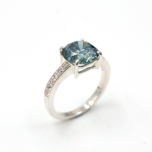 28 - Stunning : An attractive aqua oceanic  green moissanite gemstone set in a claw mount with diamond sh... 