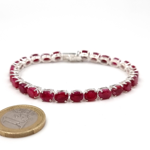 31 - Star Lot : A lovely quality 25 stone matched ruby bracelet set in sterling silver with double link c... 