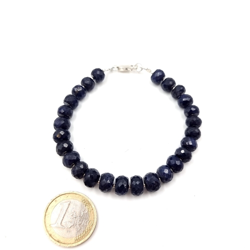 36 - A natural sapphire graduated bracelet of 26 stones. Set with a sterling silver lobster clasp. Weight... 