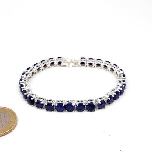 38 - Star Lot : A sapphire bright stone graduated bracelet of 28 beautifully matched gemstones. Set with ... 