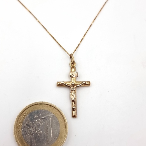 41 - A nine carat gold (375) crucifix cross together with unmarked gold chain. Length of chain - 40 cms. ... 