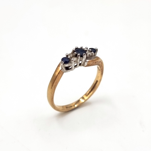 48 - Star Lot : A vintage three stone sapphire and diamond twist set mount ring set in nine carat gold (M... 