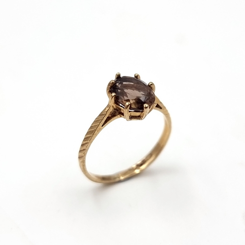 49 - A smoky quartz stone ring with claw set mount set in nine carat gold (375). Ring size - H. Weight - ... 