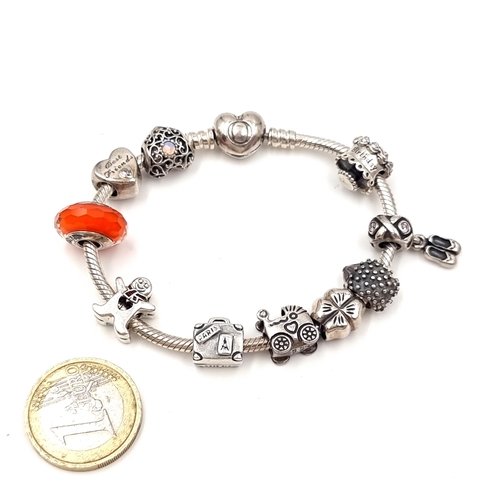 56 - A good example of a Pandora 10 charm silver bracelet. Weight - 49.48 grams. Comes in Pandora box.