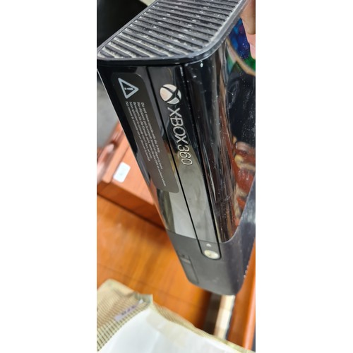 370 - An Xbox 360 E Console with additional accessories such as two controllers and headset. Cables for co... 