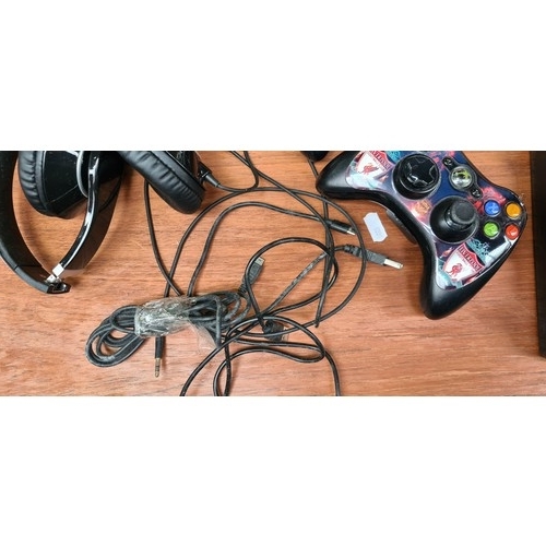 370 - An Xbox 360 E Console with additional accessories such as two controllers and headset. Cables for co... 