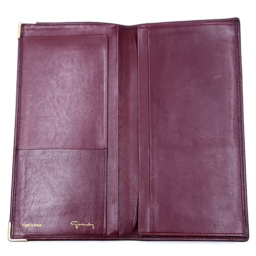 12 - A Givenchy designer  leather wallet marked in 'Made in Spain'. Dimensions: 18 x 9.5 cms. Wallet in g... 