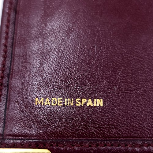 12 - A Givenchy designer  leather wallet marked in 'Made in Spain'. Dimensions: 18 x 9.5 cms. Wallet in g... 