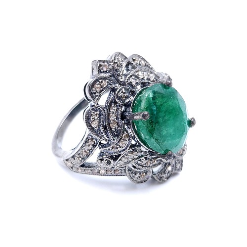 18 - Star Lot : A most attractive emerald stone ring set with a diamond foliette mount. Set in sterling s... 