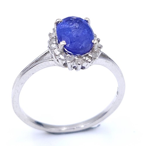 20 - Star Lot : A very nice example of a sapphire gemstone ring set with diamond surround set in sterling... 