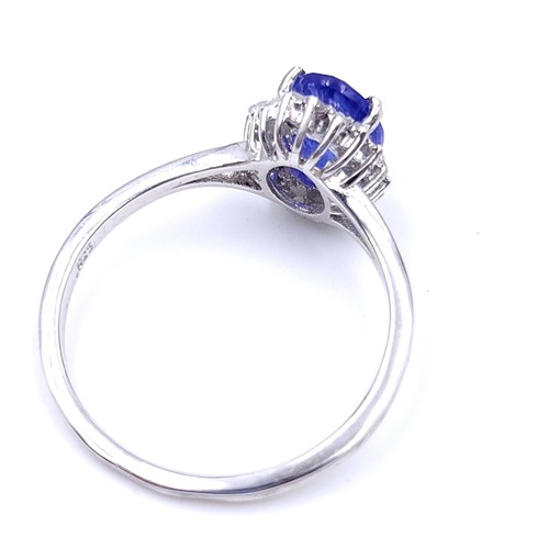 20 - Star Lot : A very nice example of a sapphire gemstone ring set with diamond surround set in sterling... 