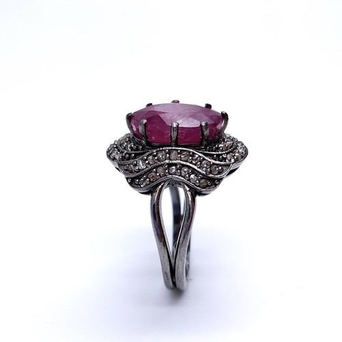 22 - Star Lot : A fabulous example of a large ruby stone ring with claw mount with a diamond surround. Ri... 