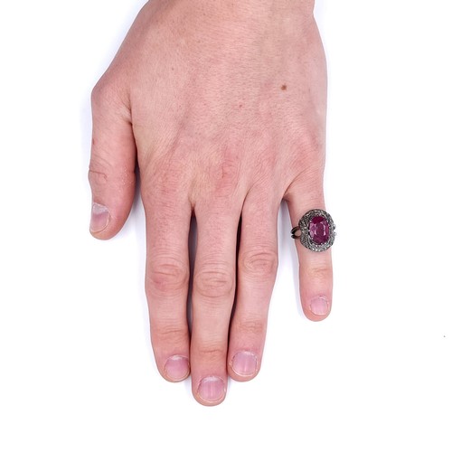 22 - Star Lot : A fabulous example of a large ruby stone ring with claw mount with a diamond surround. Ri... 