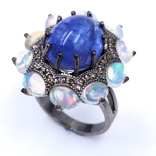 24 - Star lot : An amazing blue petal cabochon sapphire gemstone ring set with raised mount of diamond an... 