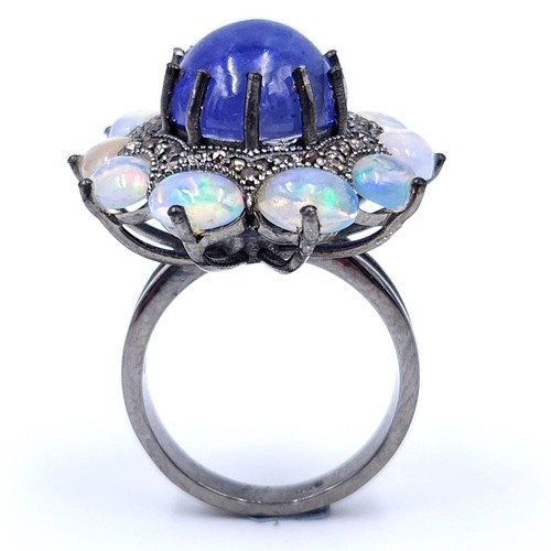 24 - Star lot : An amazing blue petal cabochon sapphire gemstone ring set with raised mount of diamond an... 