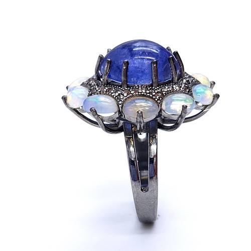 24 - Star lot : An amazing blue petal cabochon sapphire gemstone ring set with raised mount of diamond an... 