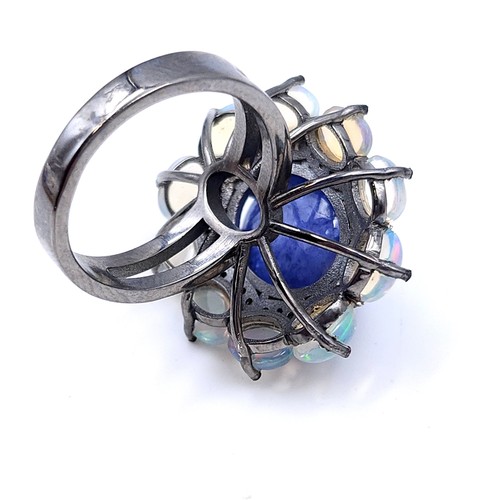 24 - Star lot : An amazing blue petal cabochon sapphire gemstone ring set with raised mount of diamond an... 