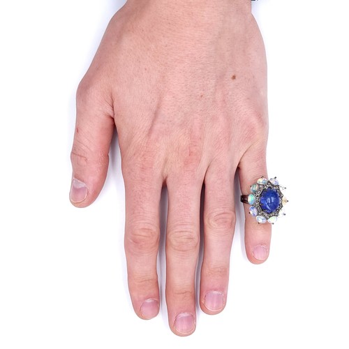 24 - Star lot : An amazing blue petal cabochon sapphire gemstone ring set with raised mount of diamond an... 