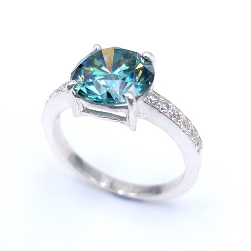 28 - Stunning : An attractive aqua oceanic  green moissanite gemstone set in a claw mount with diamond sh... 