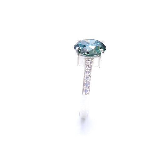 28 - Stunning : An attractive aqua oceanic  green moissanite gemstone set in a claw mount with diamond sh... 