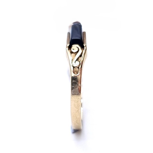 43 - An onyx stone ring set in nine carat gold (375). Size - M. Weight - 1.11 grams. Ring band misshaped.... 