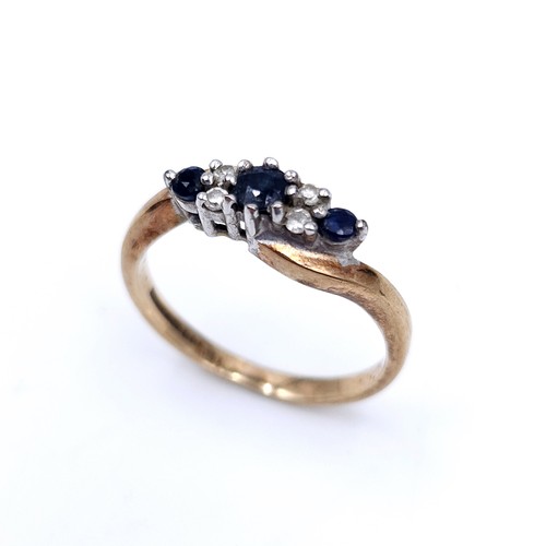 48 - Star Lot : A vintage three stone sapphire and diamond twist set mount ring set in nine carat gold (M... 