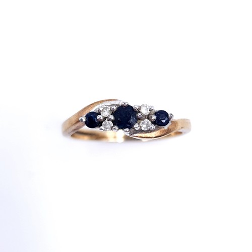 48 - Star Lot : A vintage three stone sapphire and diamond twist set mount ring set in nine carat gold (M... 